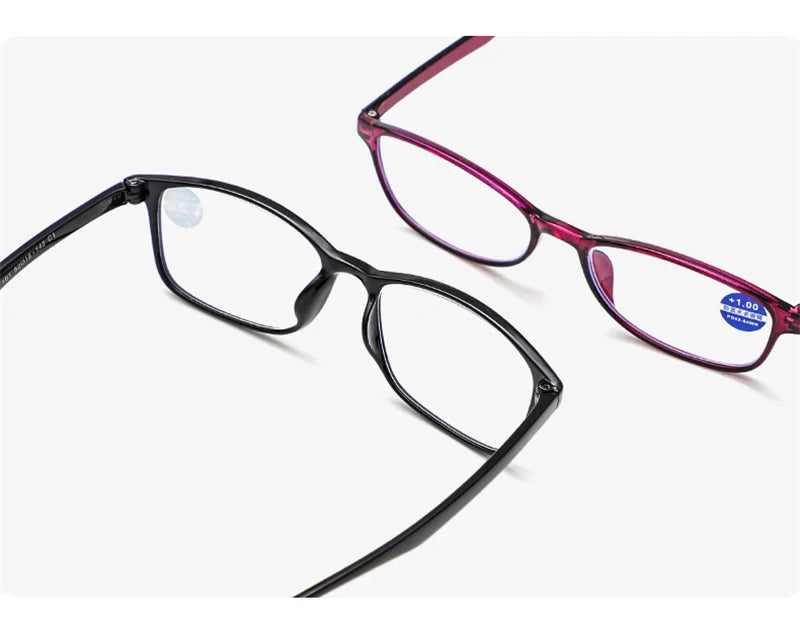 A pair of purple-framed eyeglasses with black silicone nose pads shown from the side.