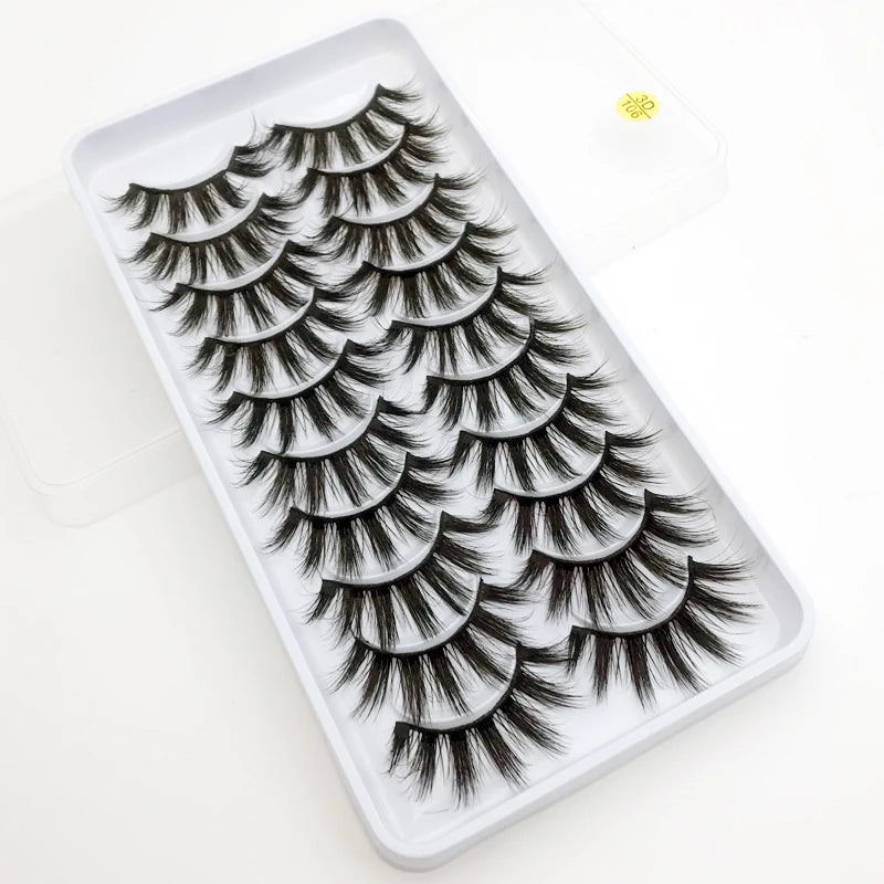 A tray of dramatic mink false eyelashes with varying lengths and styles displayed on a white background.