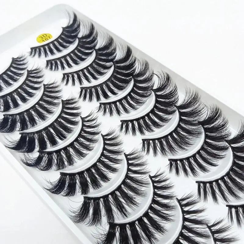 A close-up of a tray of dramatic mink false eyelashes with long, curled lashes.