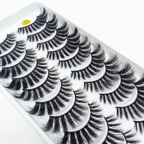 A close-up of a tray of dramatic mink false eyelashes with long, curled lashes.
