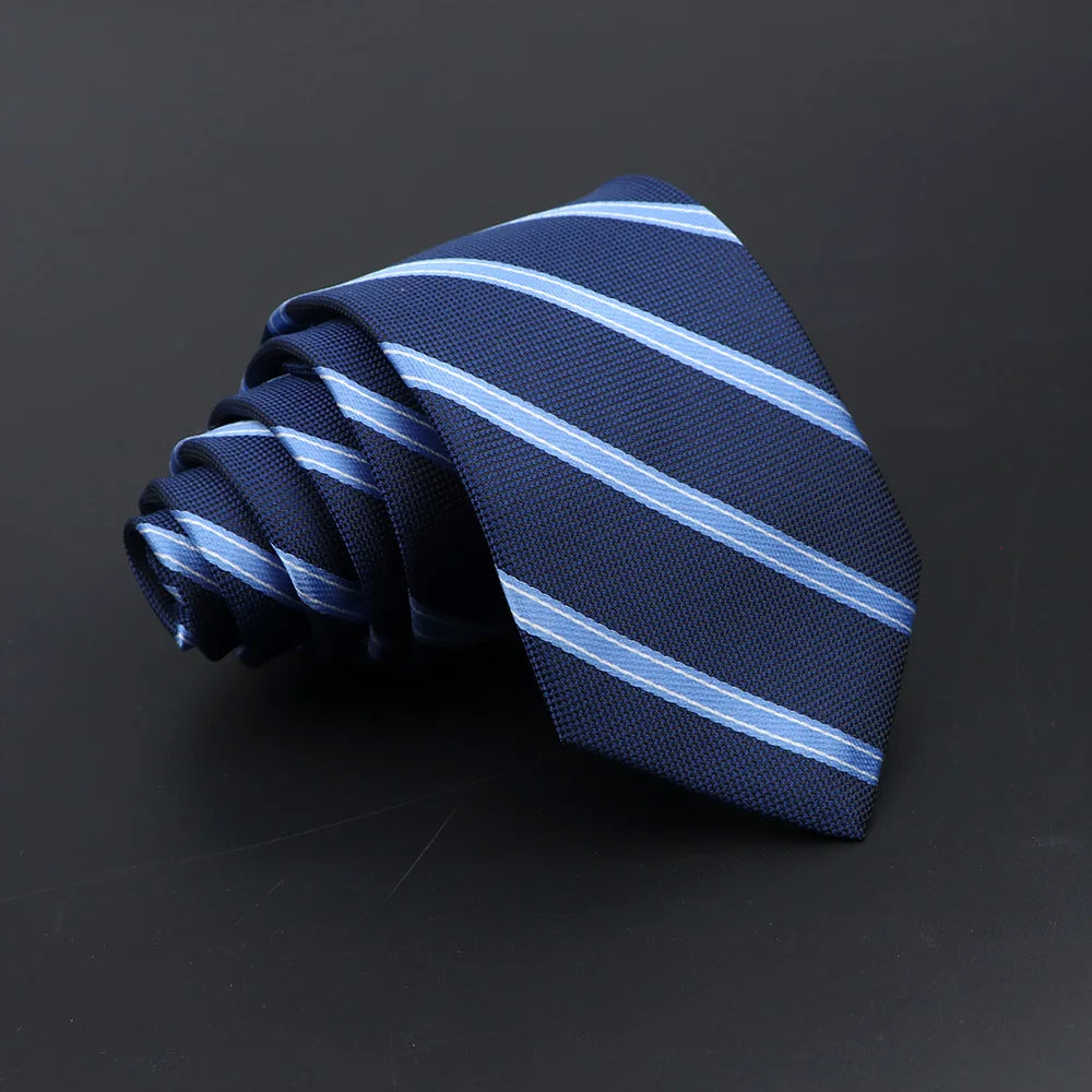 A dark blue striped necktie folded and displayed against a black background.