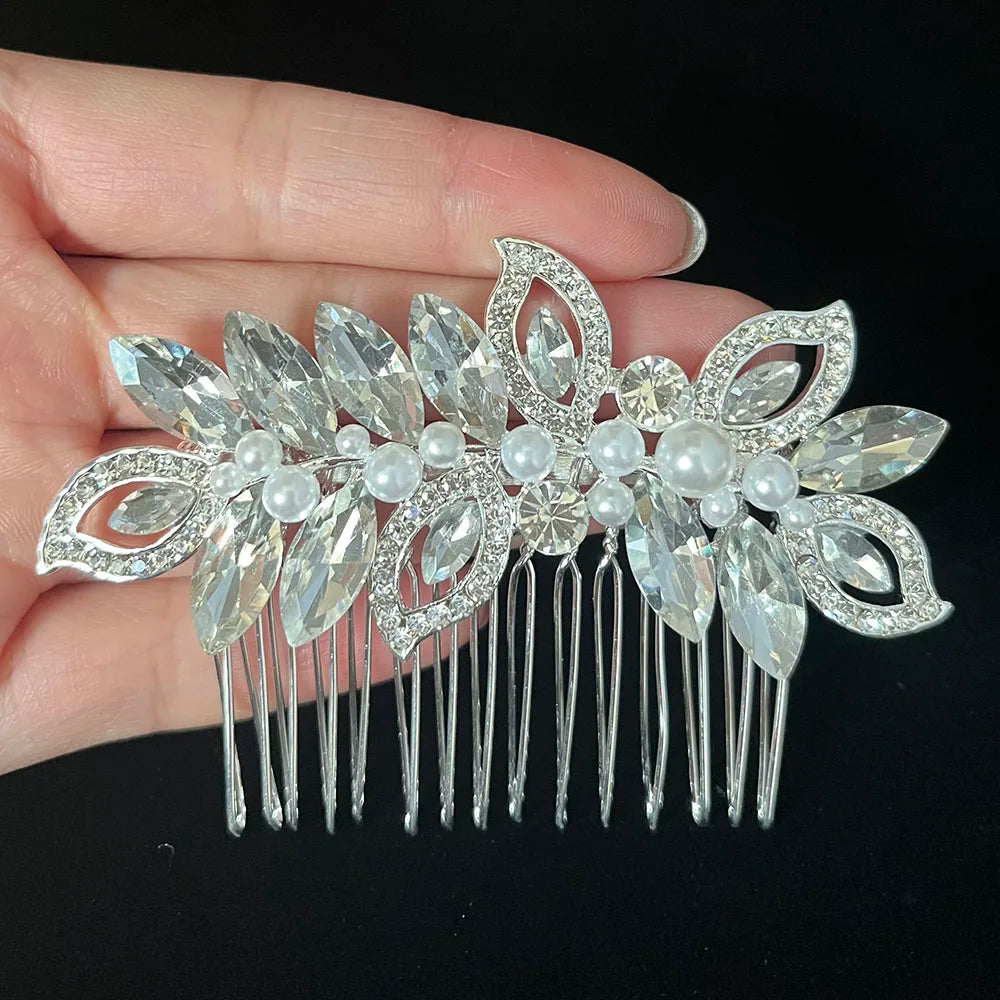 A silver rhinestone bridal hair comb featuring delicate leaves and pearl accents.
