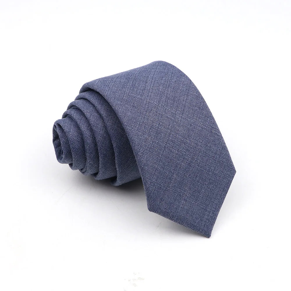 A dark blue anti-wrinkle bamboo fiber tie folded neatly on a white background.