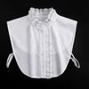 White blouse with a false collar and detachable neckline, shown flat lay against a black background.