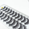 A display of dramatic mink false eyelashes arranged in a fan pattern on a white tray.