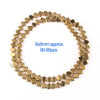 A circular arrangement of gold-plated hematite round cube beads, approximately 80-85 pieces.