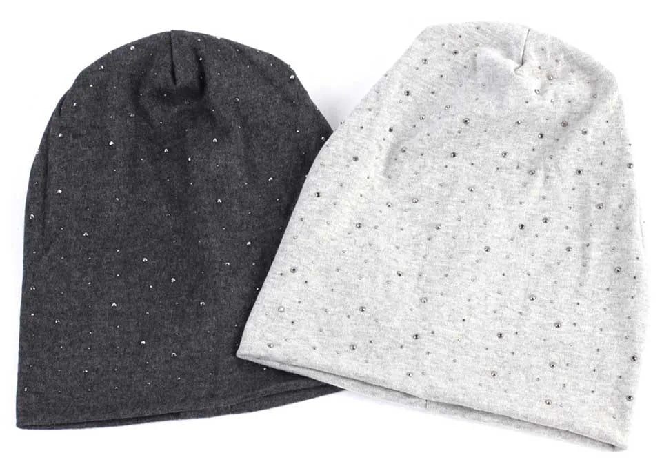 A dark gray beanie hat with small silver rhinestones next to a light gray beanie hat with small silver rhinestones.