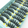 A display of black mink false eyelashes arranged on a light blue tray.