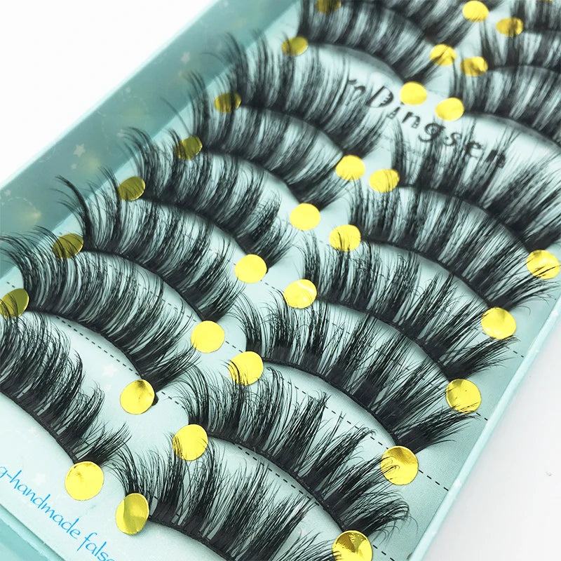 A display of black mink false eyelashes arranged on a light blue tray.