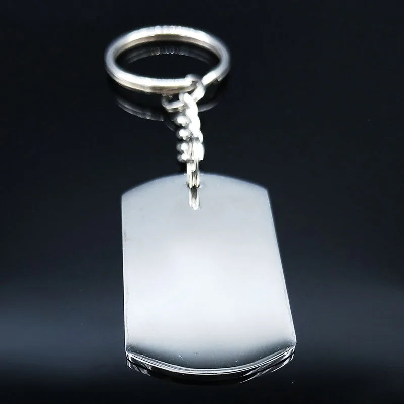 A silver stainless steel love keychain featuring a charm and a rectangular tag.