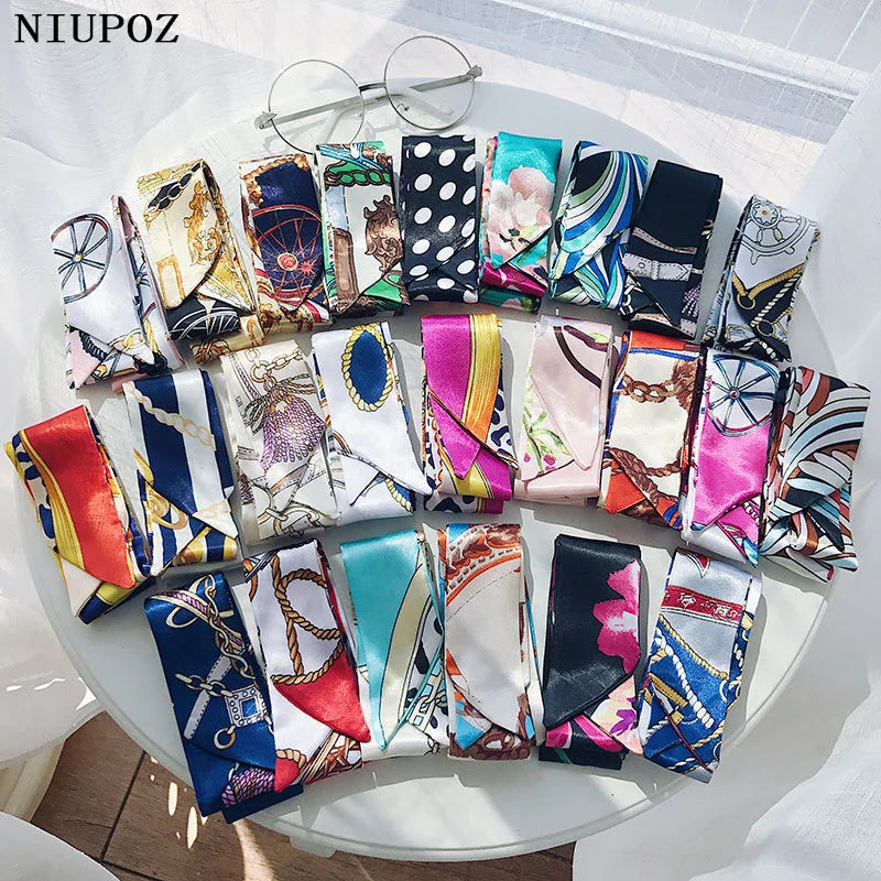 A collection of multi-color silk headbands and scarves featuring various patterns including leopard print, floral designs, an