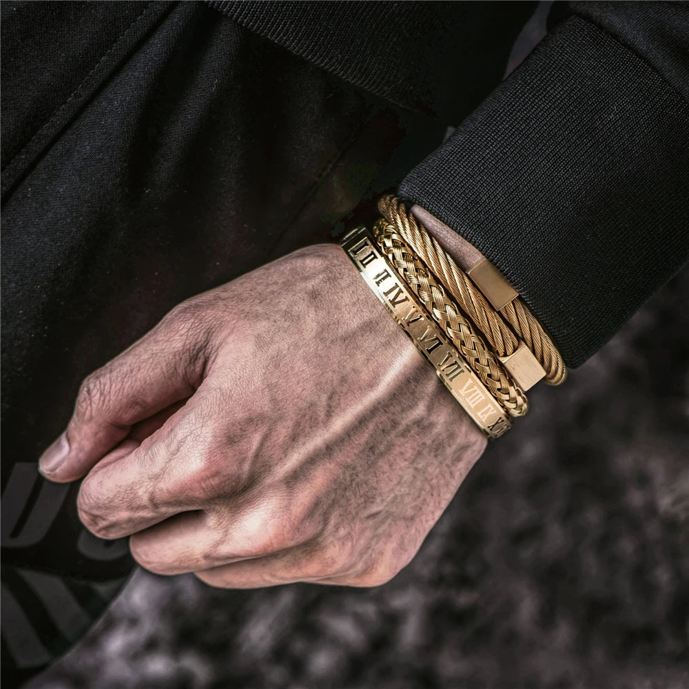 A hand wearing a luxury Roman number stainless steel bracelet on a black sleeve.