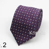 A purple necktie with a small blue dot pattern folded and displayed on a white background.