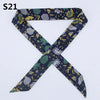 A dark blue silk headband scarf featuring a multi-color leopard print pattern.
