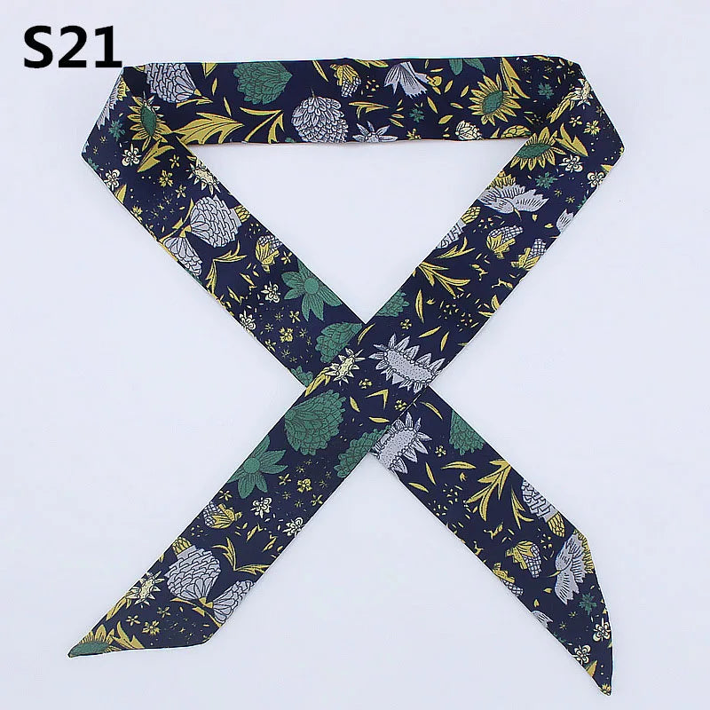 A dark blue silk headband scarf featuring a multi-color leopard print pattern.