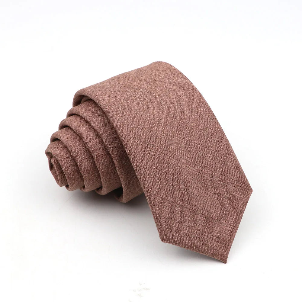 A folded men's solid color anti-wrinkle bamboo fiber tie in a dusty rose or mauve shade.