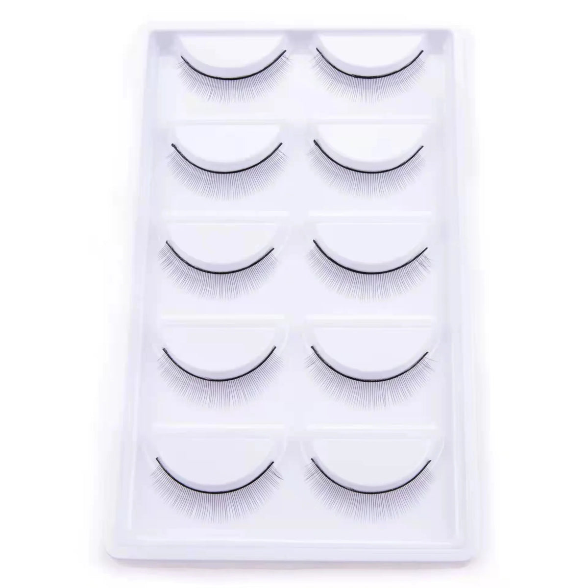A white plastic tray holding multiple pairs of mink false eyelashes