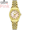 A gold-toned quartz wristwatch with a pink dial and gold accents on a light background.