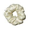 A beige luxury pure silk hair scrunchie tied in a voluminous, gathered bow.