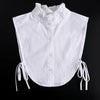 White blouse with a ruffled false collar and tie strings at the sleeves