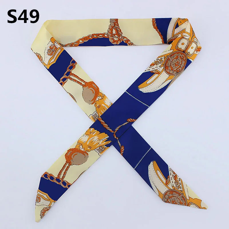 A silk headband scarf featuring a multi-color leopard print design with gold and orange accents.