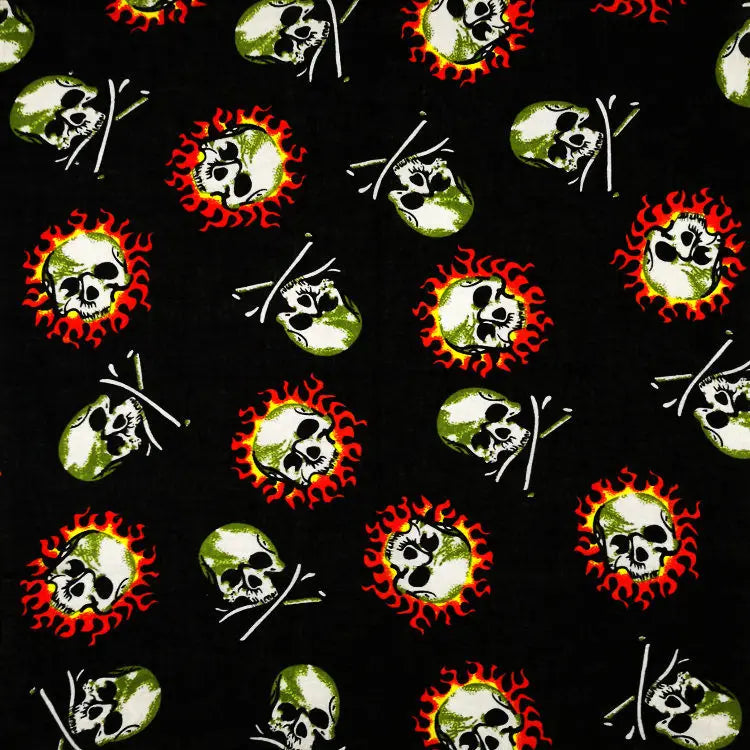 Patrón de calaveras verdes con llamas rojas sobre tela negra