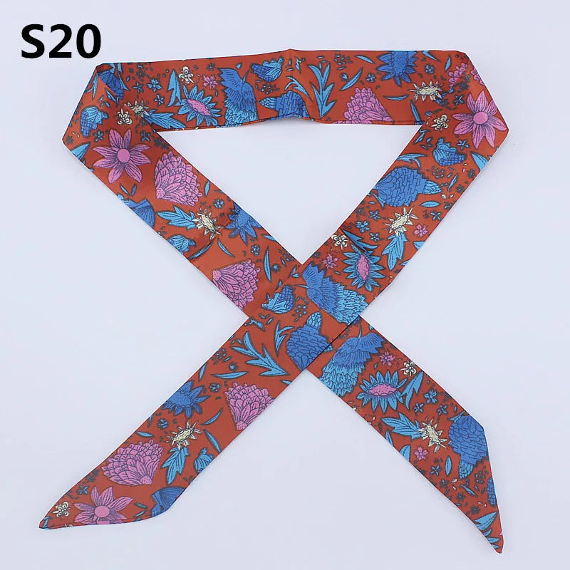 A silk headband scarf featuring a multi-color leopard print design with floral patterns.