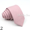A rolled pink tie, No. 2, made of anti-wrinkle bamboo fiber.