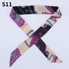 A silk headband scarf featuring a multi-color leopard print design with intricate patterns.