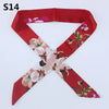 A red silk headband scarf featuring a multi-color floral print design.