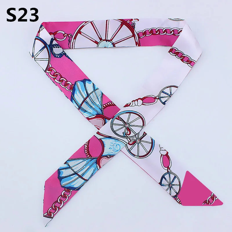 A pink and white silk headband scarf featuring a leopard print design with circular motifs.