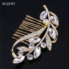 A gold-toned bridal hair comb featuring sparkling clear rhinestones and leaf motifs.