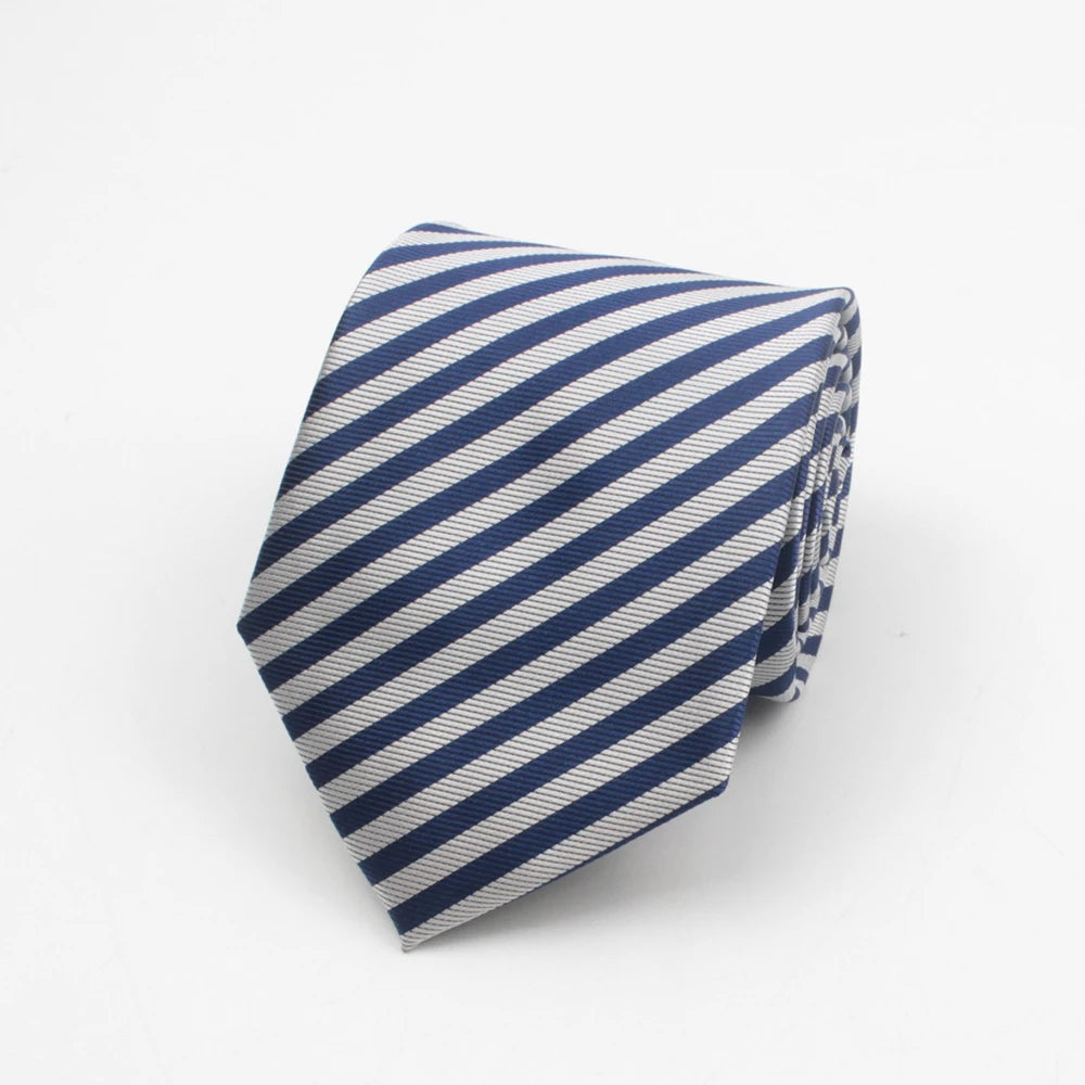 A navy blue and white striped necktie with a subtle dot pattern folded on a white background.