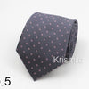 A dark gray necktie with a subtle pattern of small pink dots on a white background.
