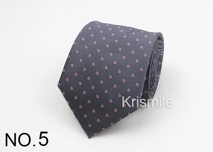 A dark gray necktie with a subtle pattern of small pink dots on a white background.