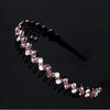 A delicate pink and clear rhinestone anti-slip hairband featuring small, sparkling stones.