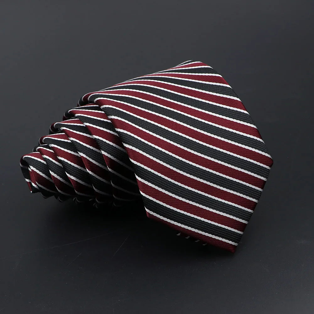 A close-up of a folded classic men's tie featuring diagonal stripes in maroon and black.