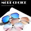 A pair of classic metal aviator sunglasses with a gradient black driver style frame and blue lenses displayed on a white surf