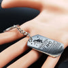 A silver stainless steel keychain engraved with 'Para Mi Esposa Te Amo' attached to a finger.