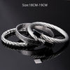 A silver stainless steel bracelet with Roman numerals is displayed on a dark surface.