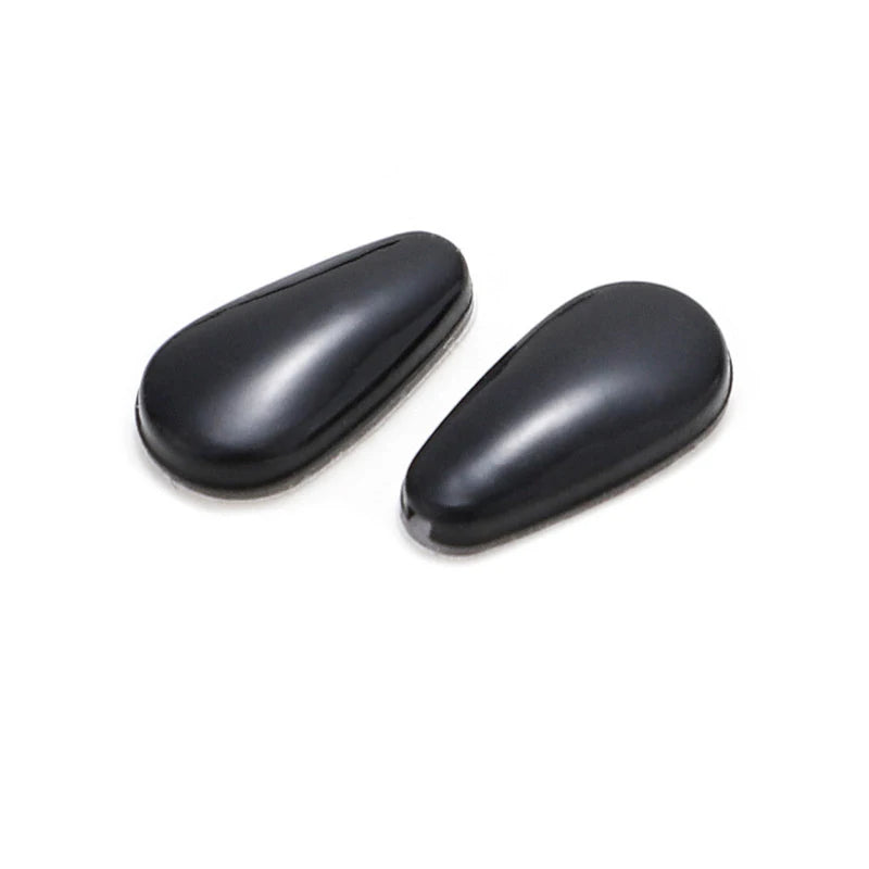 A pair of black silicone nose pads for eyeglasses.