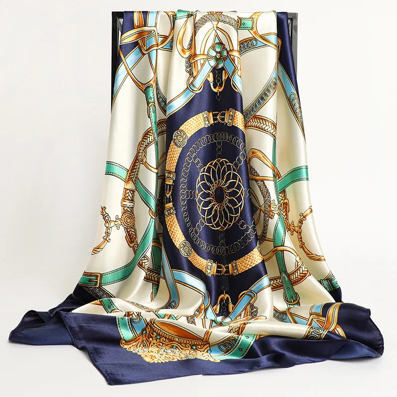 A luxurious satin silk scarf featuring blue, gold, and cream patterns draped elegantly.