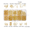 A collection of gold jewelry findings including clasps, hooks, jump rings, and various sizes packaged in compartments.