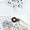 A collection of knitted hair scrunchie headbands in various patterns and colors displayed on a white surface.
