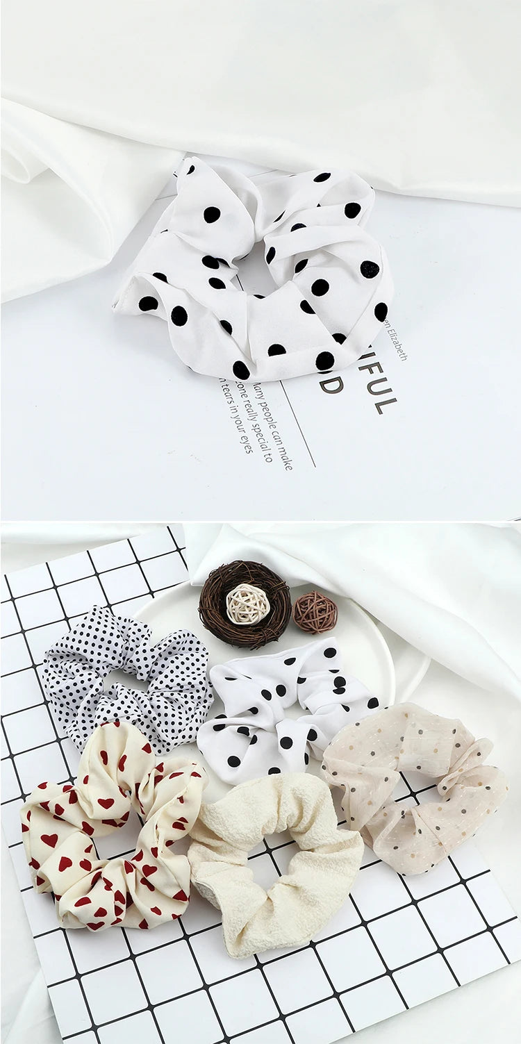 A collection of knitted hair scrunchie headbands in various patterns and colors displayed on a white surface.