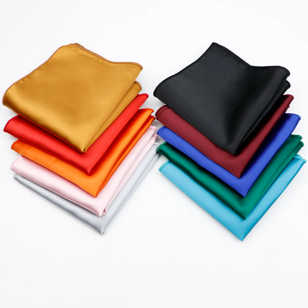 A stack of vintage silk satin men's pocket squares in various colors including gold, red, orange, black, and blue.