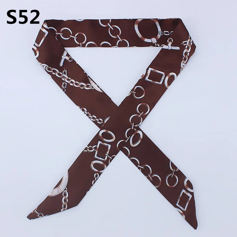 A dark brown silk headband scarf featuring a chain motif print.