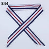 A striped silk headband scarf featuring navy blue, white, and red colors.