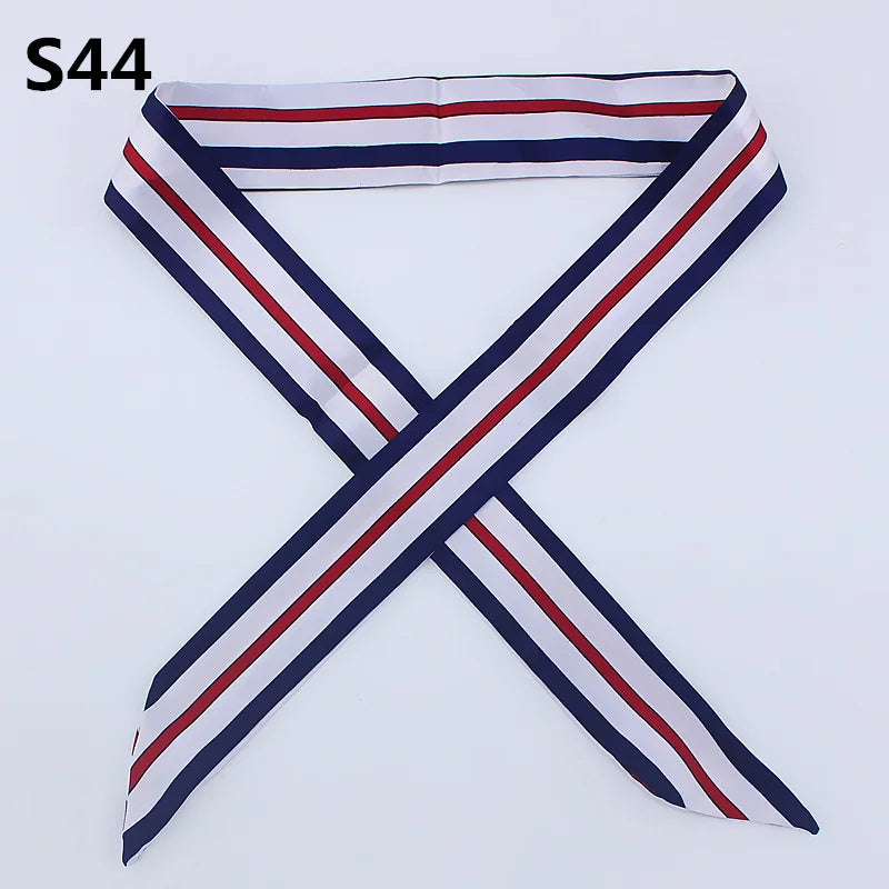 A striped silk headband scarf featuring navy blue, white, and red colors.