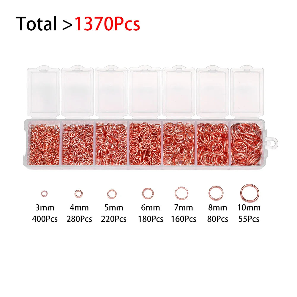 A set of clear plastic containers holding various colored jewelry findings like beads and rings.